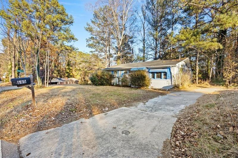 685 Bolton Road Northwest Atlanta, GA 30331 - Photo 18 of 21 a view of a house with a yard covered in snow