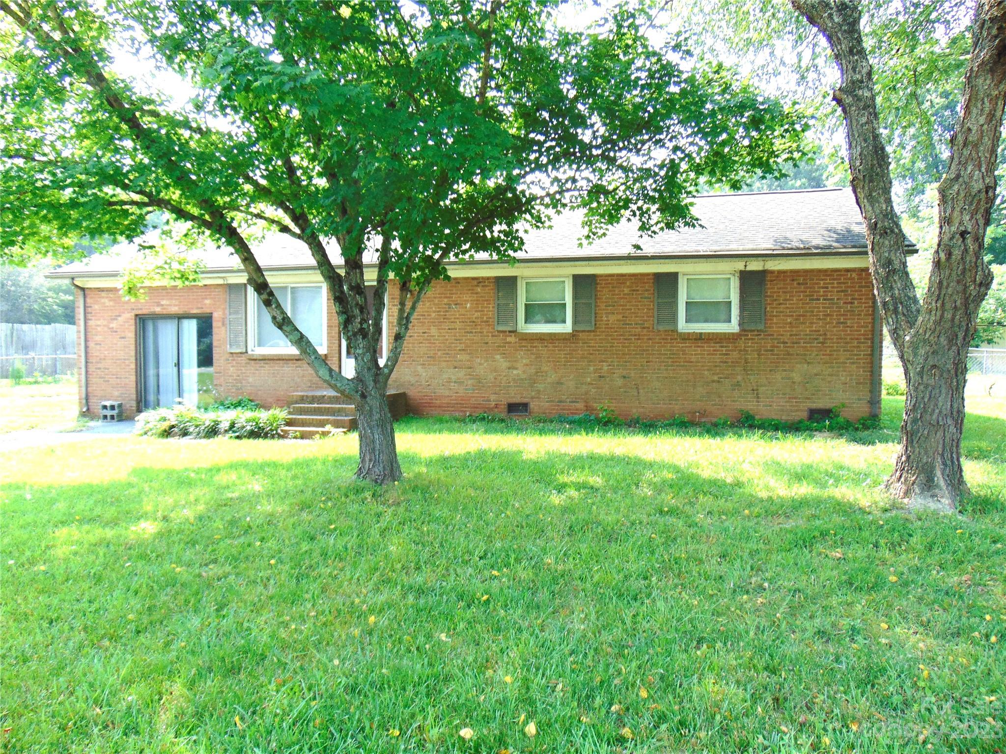 1200 Stallings Road Matthews, NC 28104 - Photo 1 of 17 a view of a yard in front of a house with large trees