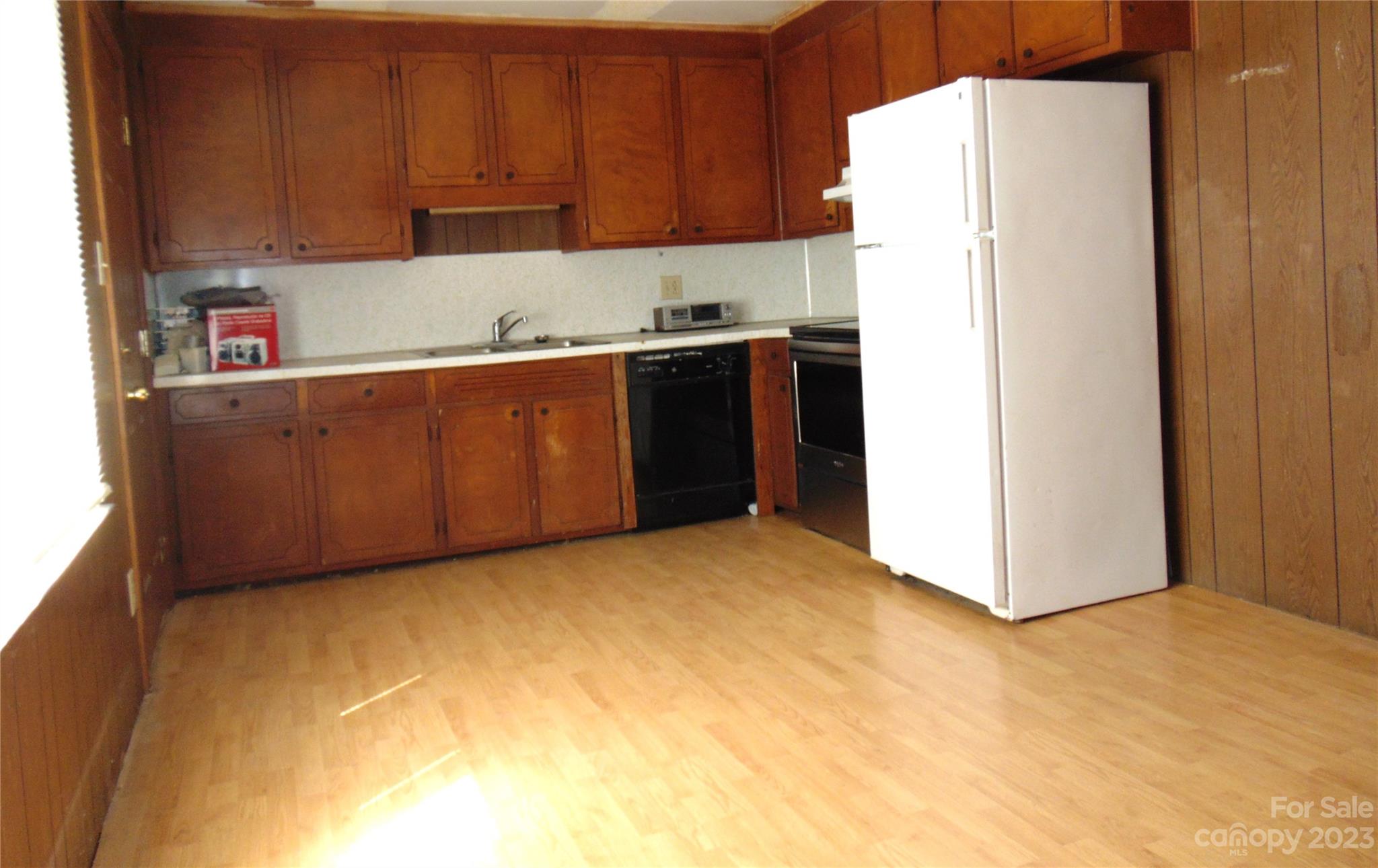 1200 Stallings Road Matthews, NC 28104 - Photo 5 of 17 a kitchen with a refrigerator and cabinets