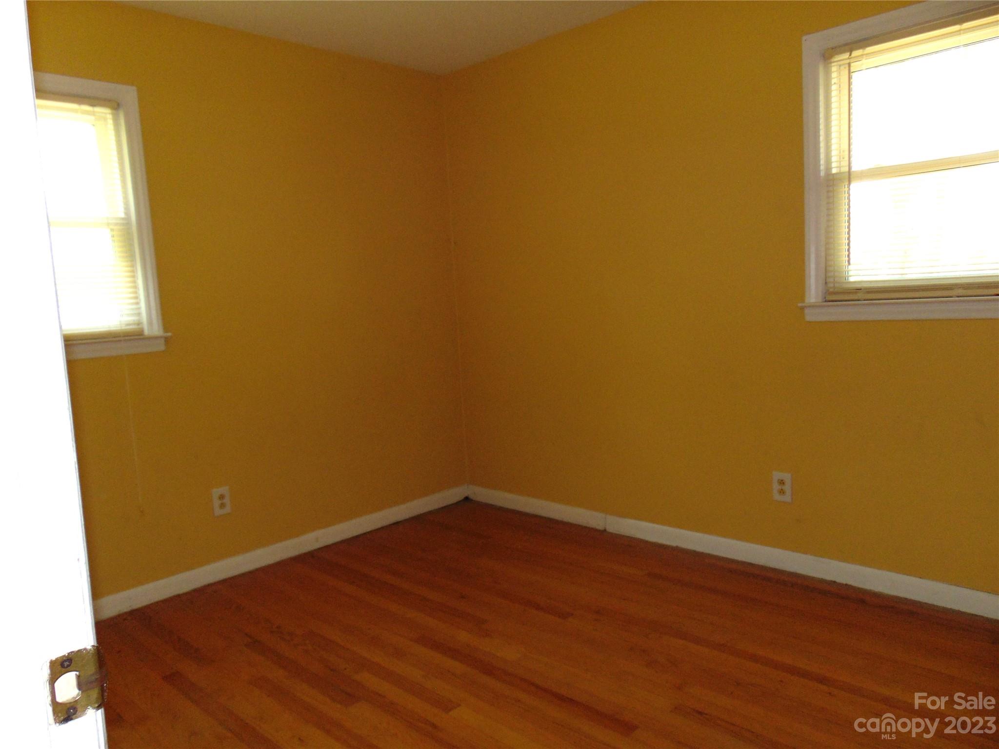 1200 Stallings Road Matthews, NC 28104 - Photo 8 of 17 an empty room with wooden floor and windows