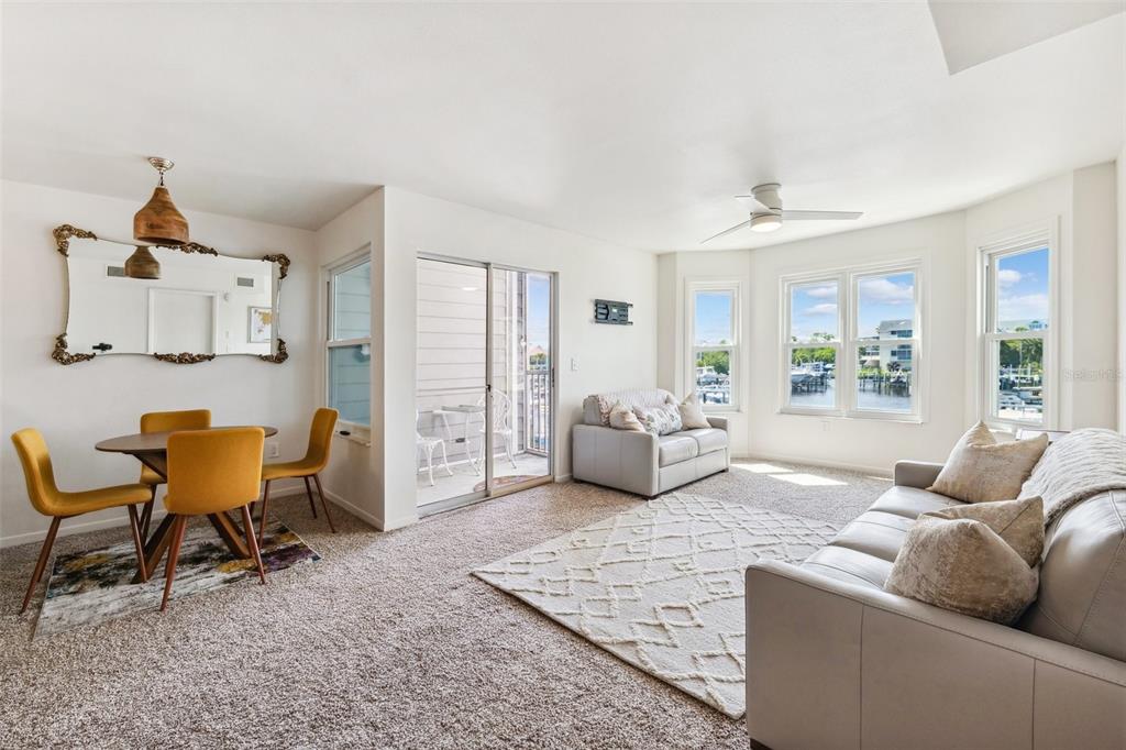 5712 Biscayne Court, Unit 103 New Port Richey, FL 34652 - Photo 11 of 31 a living room with furniture and a large window