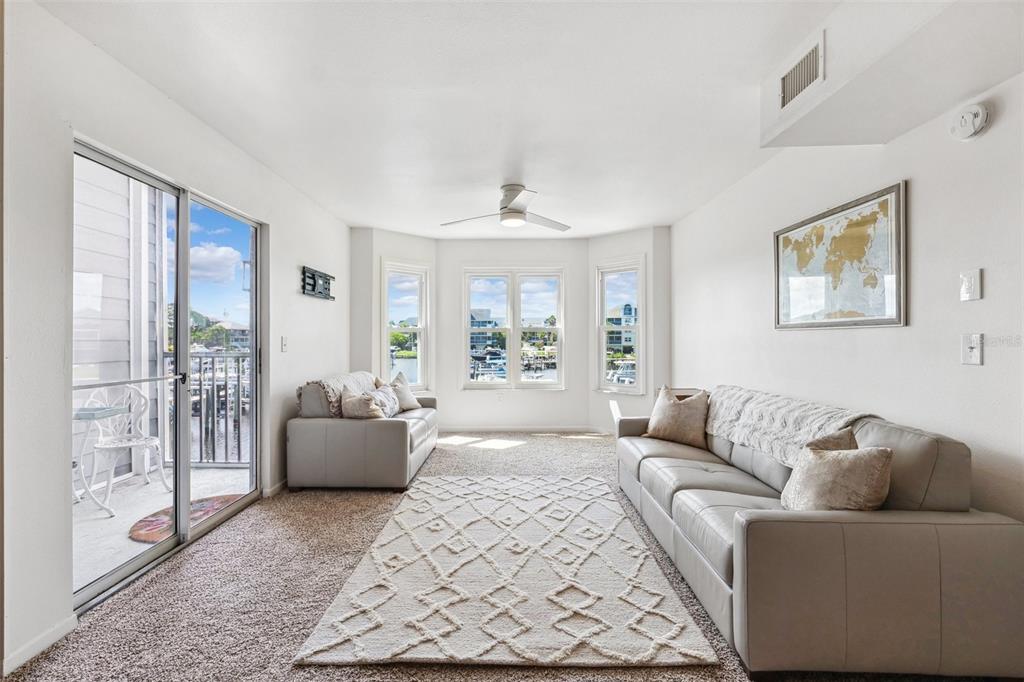 5712 Biscayne Court, Unit 103 New Port Richey, FL 34652 - Photo 12 of 31 a living room with furniture and a large window