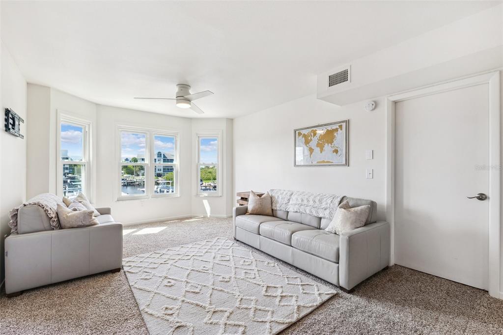 5712 Biscayne Court, Unit 103 New Port Richey, FL 34652 - Photo 14 of 31 a living room with furniture and a large window