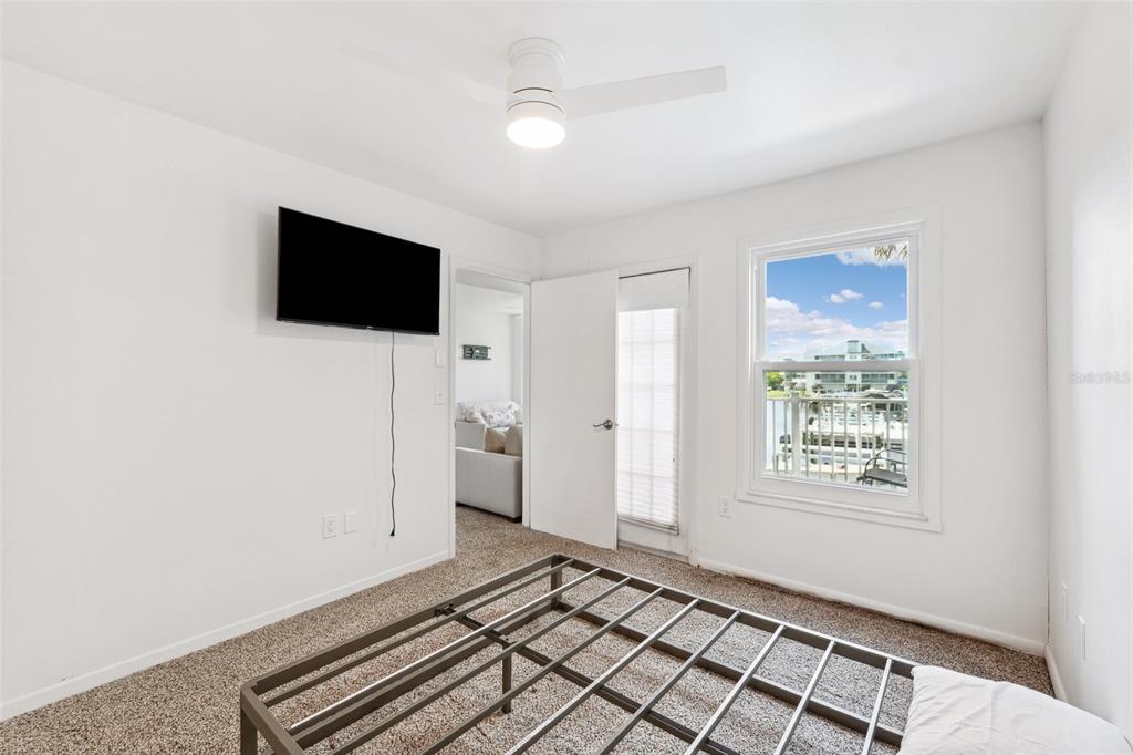 5712 Biscayne Court, Unit 103 New Port Richey, FL 34652 - Photo 17 of 31 a view of an empty room with a window and a flat screen tv