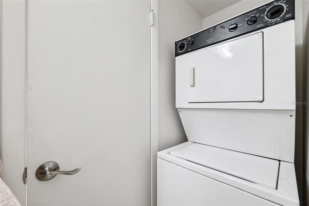 5712 Biscayne Court, Unit 103 New Port Richey, FL 34652 - Photo 18 of 31 a utility room with dryer and washer