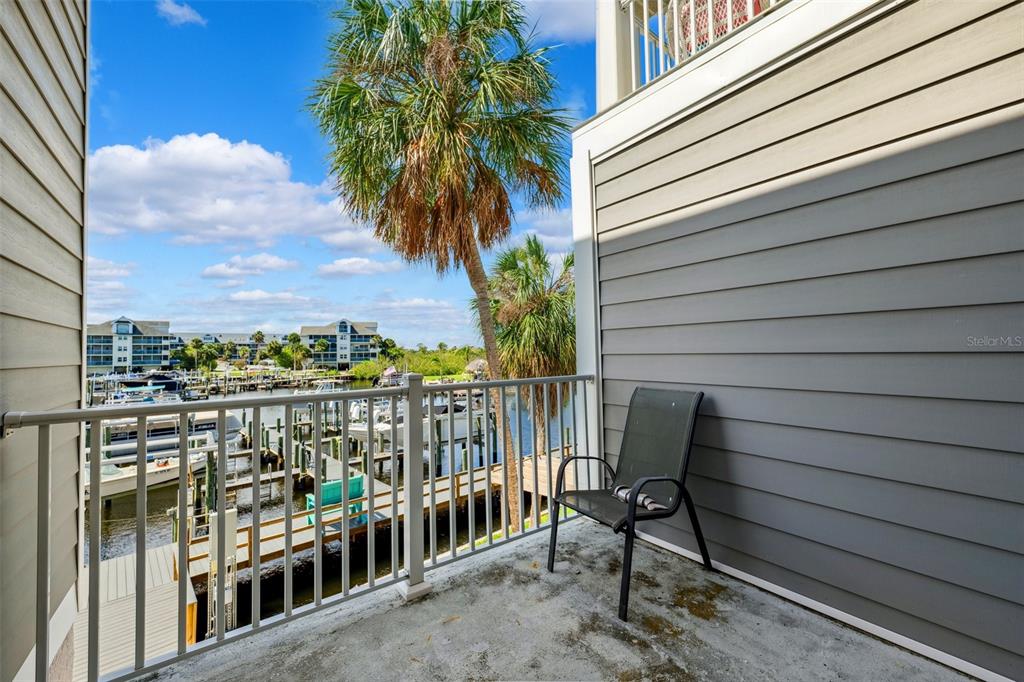 5712 Biscayne Court, Unit 103 New Port Richey, FL 34652 - Photo 3 of 31 a view of a chair and table in the balcony