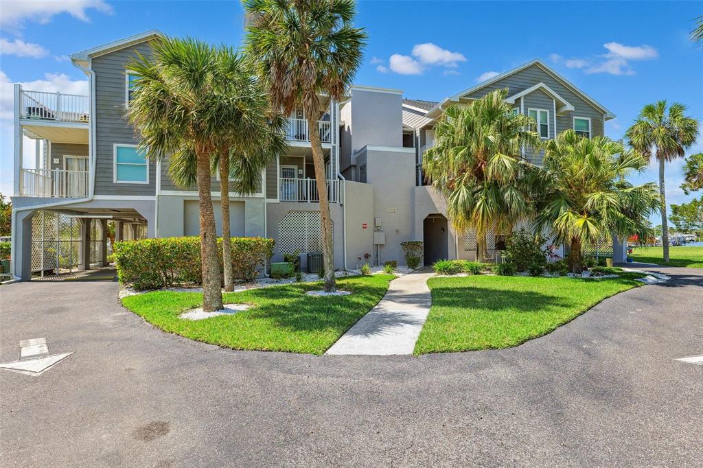 5712 Biscayne Court, Unit 103 New Port Richey, FL 34652 - Photo 31 of 31 a front view of a house with garden