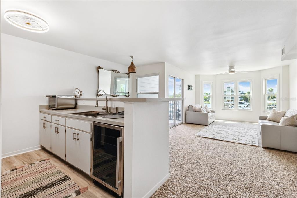 5712 Biscayne Court, Unit 103 New Port Richey, FL 34652 - Photo 9 of 31 a kitchen with stainless steel appliances granite countertop a stove a sink and a refrigerator