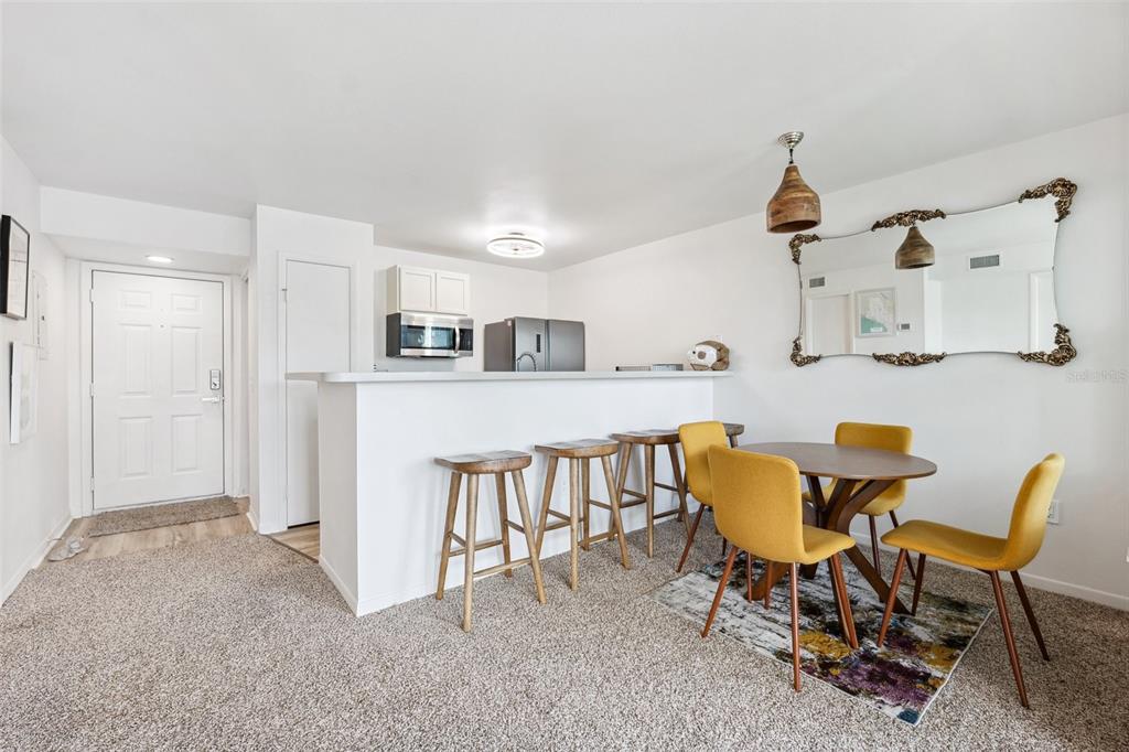 5712 Biscayne Court, Unit 103 New Port Richey, FL 34652 - Photo 10 of 31 a view of kitchen and dining area with furniture
