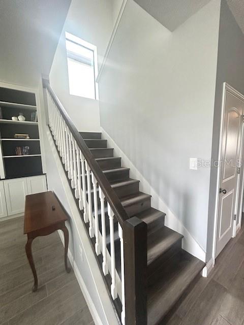 13850 Moosehead Circle Hudson, FL 34669 - Photo 12 of 71 a view of staircase with lots of frames on wall and windows