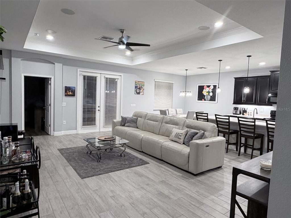 13850 Moosehead Circle Hudson, FL 34669 - Photo 13 of 71 a living room with furniture kitchen view and a wooden floor