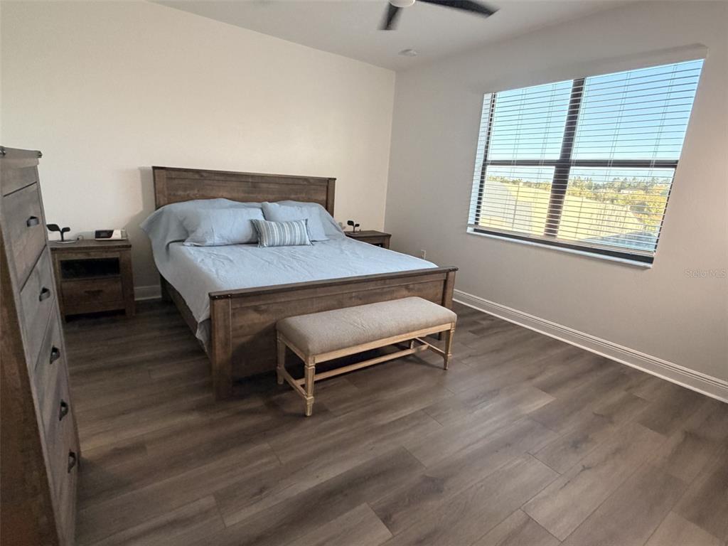 13850 Moosehead Circle Hudson, FL 34669 - Photo 19 of 71 a bedroom with a bed and wooden floor