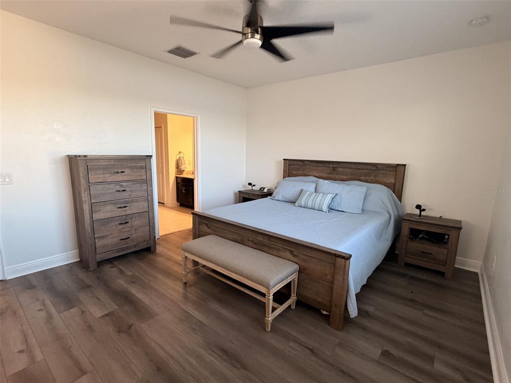 13850 Moosehead Circle Hudson, FL 34669 - Photo 20 of 71 a bedroom with a bed and a dresser