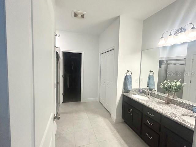 13850 Moosehead Circle Hudson, FL 34669 - Photo 21 of 71 a spacious bathroom with a double vanity sink and a mirror