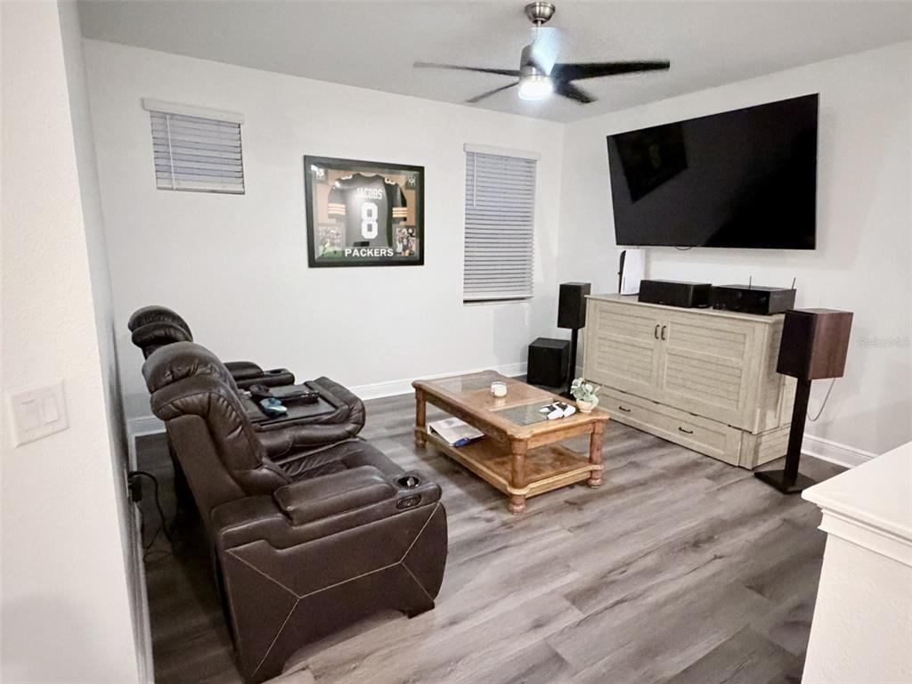 13850 Moosehead Circle Hudson, FL 34669 - Photo 25 of 71 a living room with furniture and a flat screen tv
