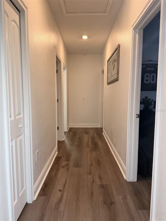 13850 Moosehead Circle Hudson, FL 34669 - Photo 27 of 71 a view of a hallway with wooden floor and closet