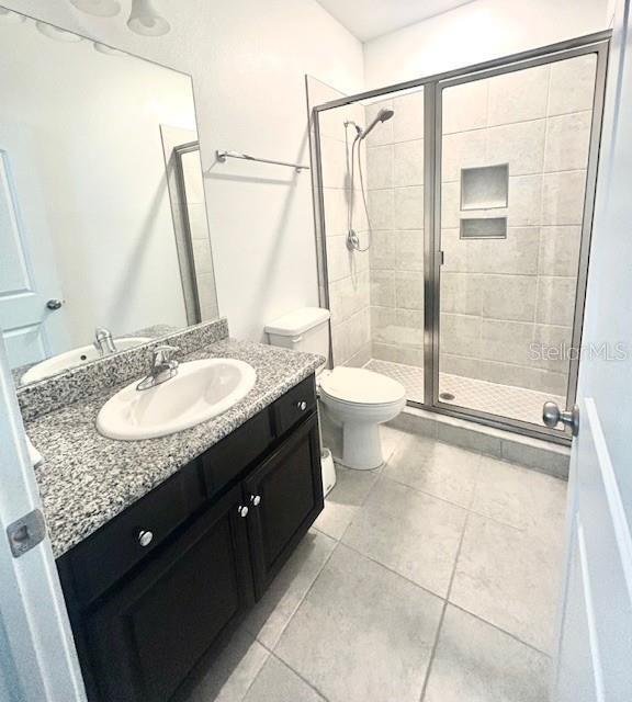 13850 Moosehead Circle Hudson, FL 34669 - Photo 30 of 71 a bathroom with a granite countertop sink a toilet and shower