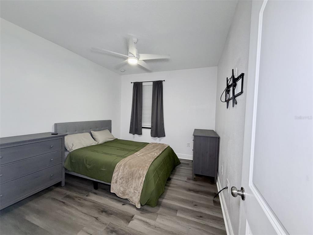13850 Moosehead Circle Hudson, FL 34669 - Photo 31 of 71 a bedroom with a bed and a chandelier