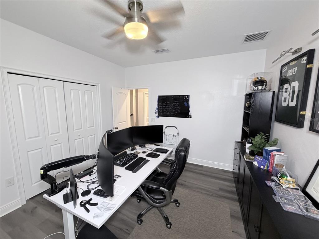 13850 Moosehead Circle Hudson, FL 34669 - Photo 33 of 71 a work room with furniture and a flat screen tv