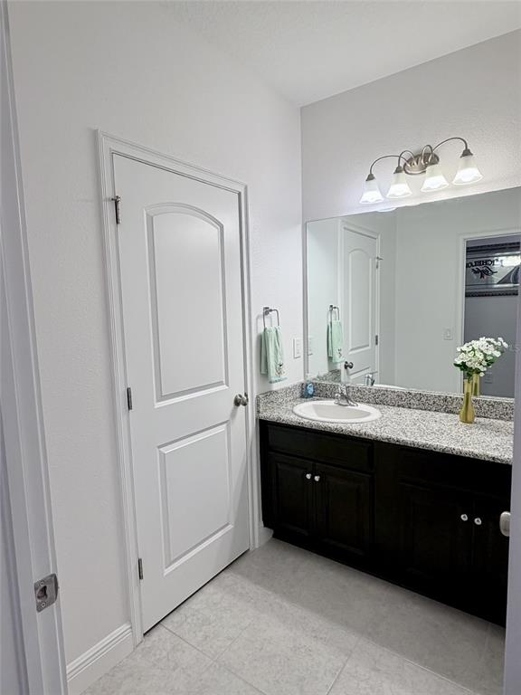 13850 Moosehead Circle Hudson, FL 34669 - Photo 34 of 71 a bathroom with a double vanity sink and mirror
