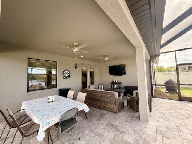 13850 Moosehead Circle Hudson, FL 34669 - Photo 38 of 71 a living room with furniture and a flat screen tv