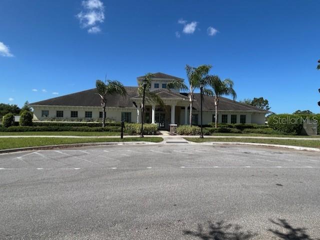 13850 Moosehead Circle Hudson, FL 34669 - Photo 46 of 71 a front view of a house with a garden