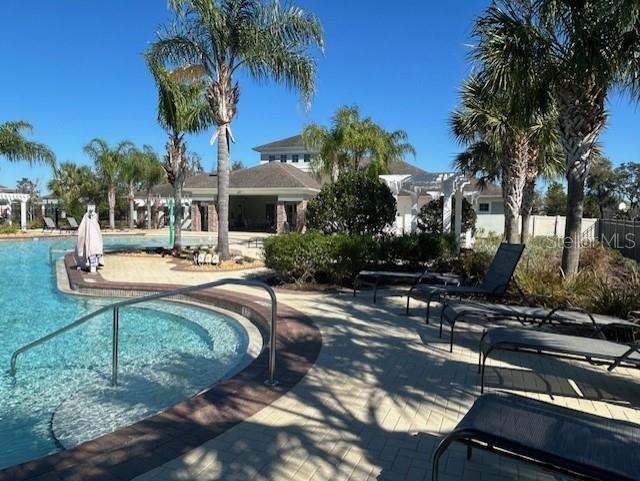 13850 Moosehead Circle Hudson, FL 34669 - Photo 50 of 71 a view of a swimming pool with a patio