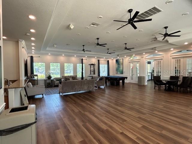 13850 Moosehead Circle Hudson, FL 34669 - Photo 54 of 71 a living room with lots of furniture and wooden floor