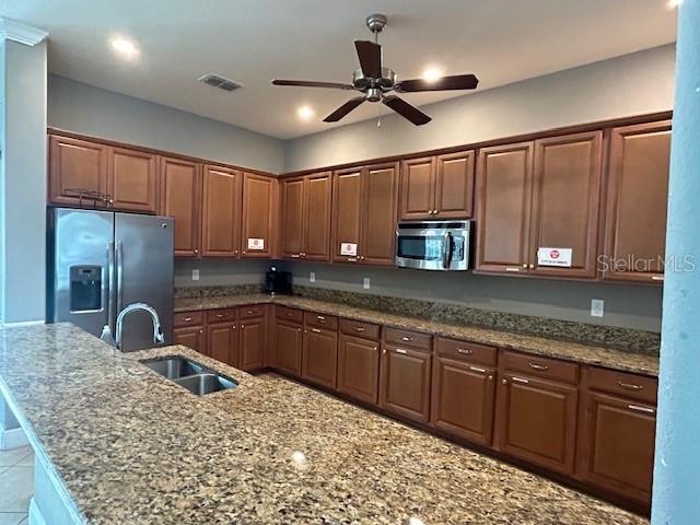 13850 Moosehead Circle Hudson, FL 34669 - Photo 56 of 71 a kitchen with stainless steel appliances granite countertop a sink stove and refrigerator