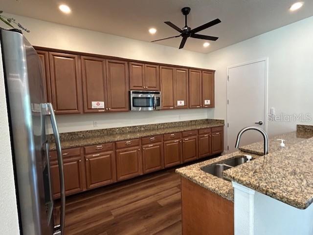 13850 Moosehead Circle Hudson, FL 34669 - Photo 57 of 71 a kitchen with stainless steel appliances granite countertop a sink refrigerator and microwave