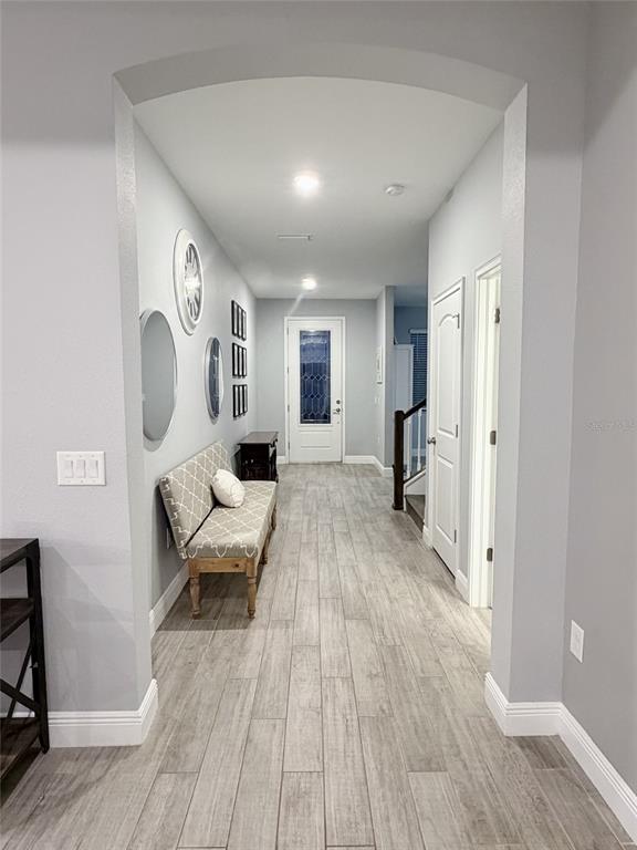 13850 Moosehead Circle Hudson, FL 34669 - Photo 8 of 71 a spacious bedroom with a bed and wooden floor