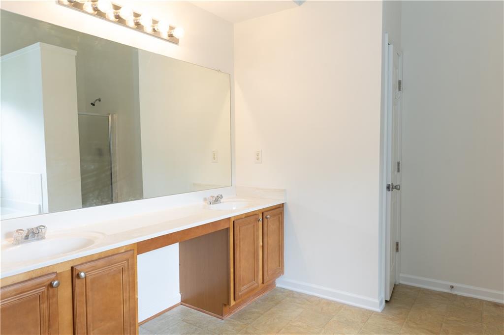 502 Streamside Place Canton, GA 30115 - Photo 22 of 33 a bathroom with a sink and a mirror
