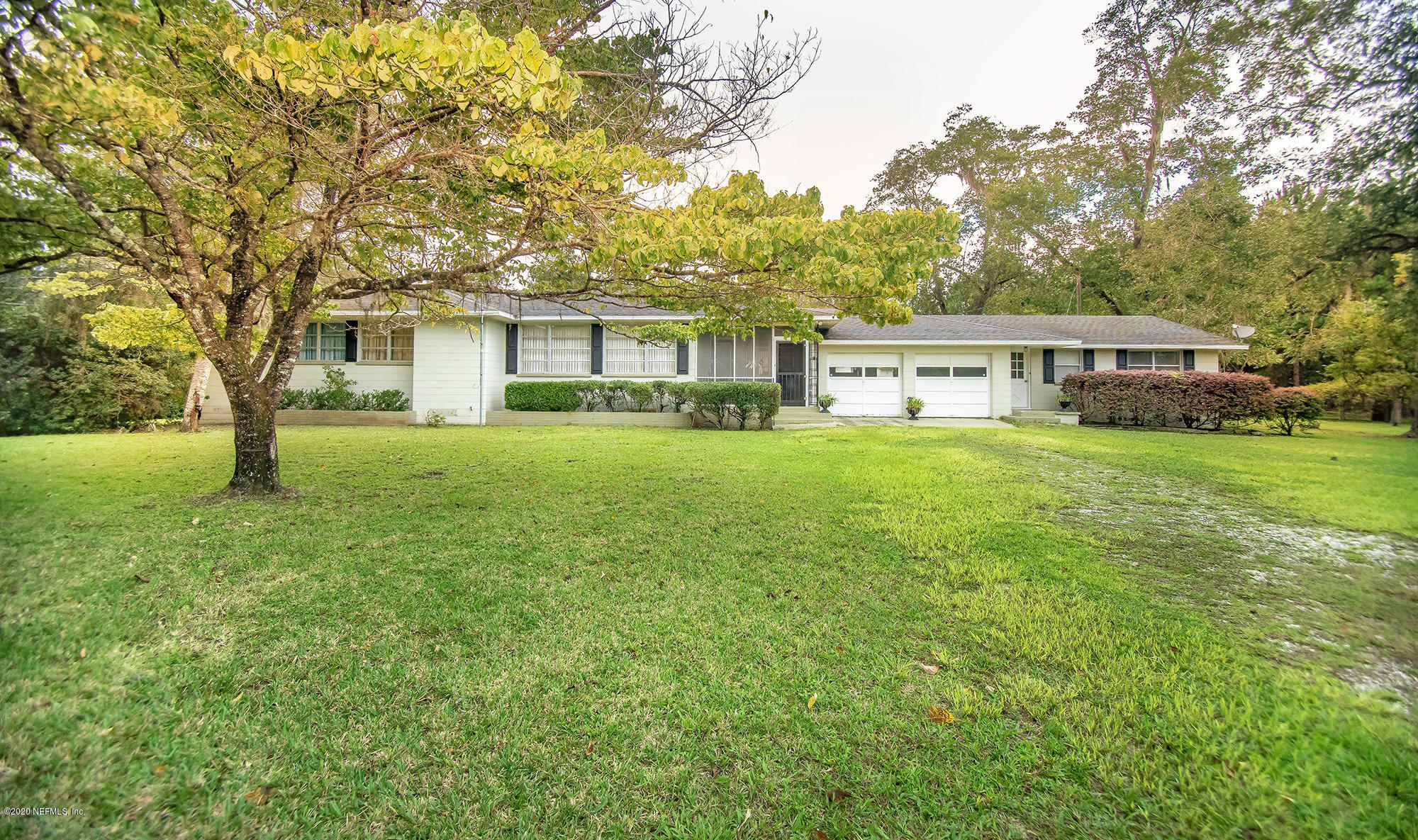 281105 Trigg Road Hilliard, FL 32046 - Photo 1 of 41 a view of a house with a big yard and large trees