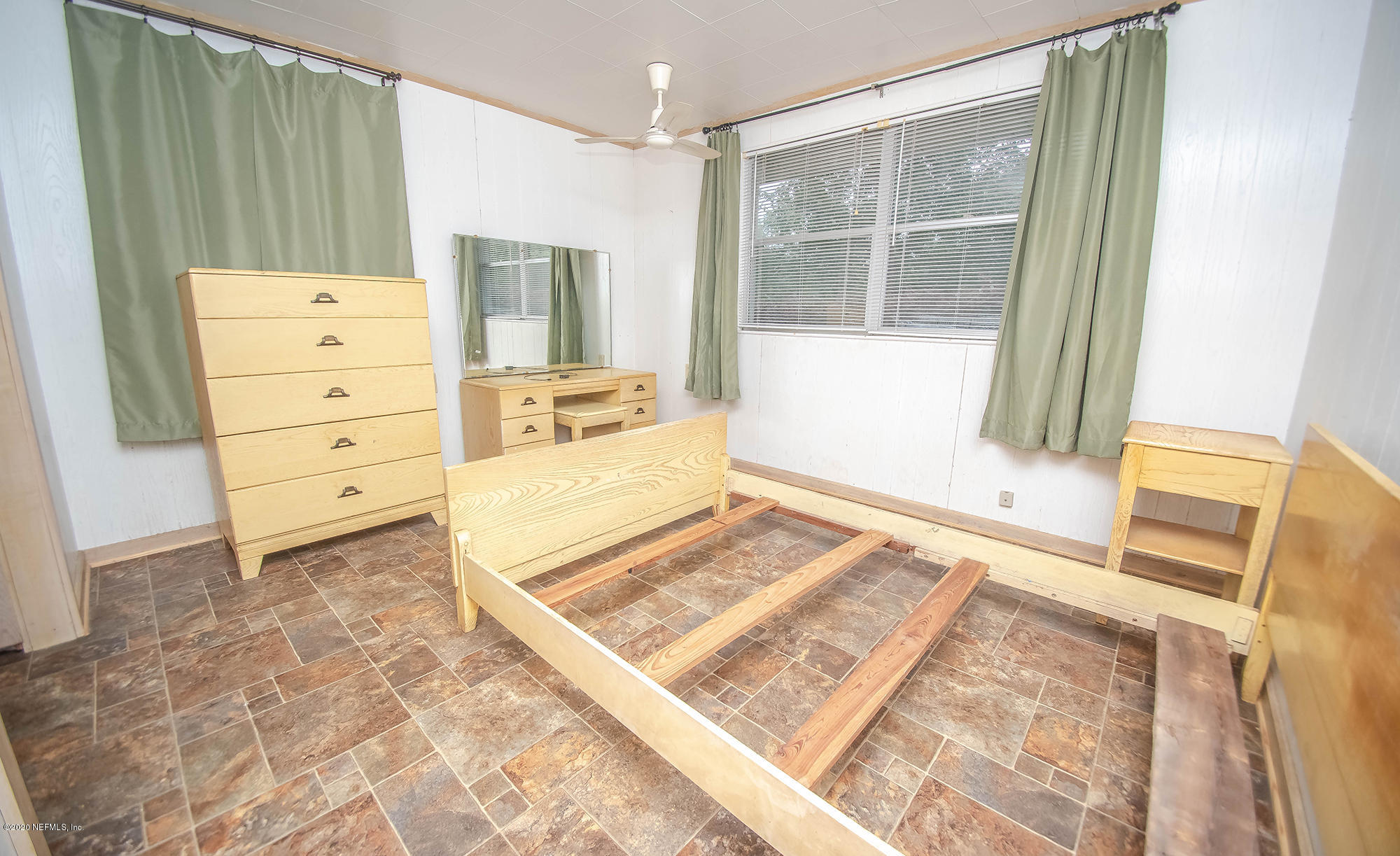 281105 Trigg Road Hilliard, FL 32046 - Photo 25 of 41 a view of a bedroom with wooden floor and windows