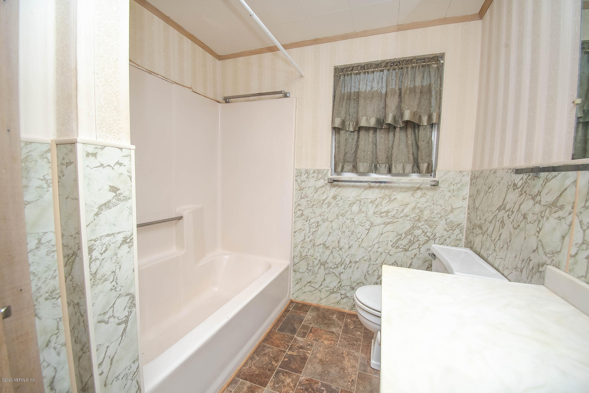 281105 Trigg Road Hilliard, FL 32046 - Photo 26 of 41 a bathroom with a bathtub and shower