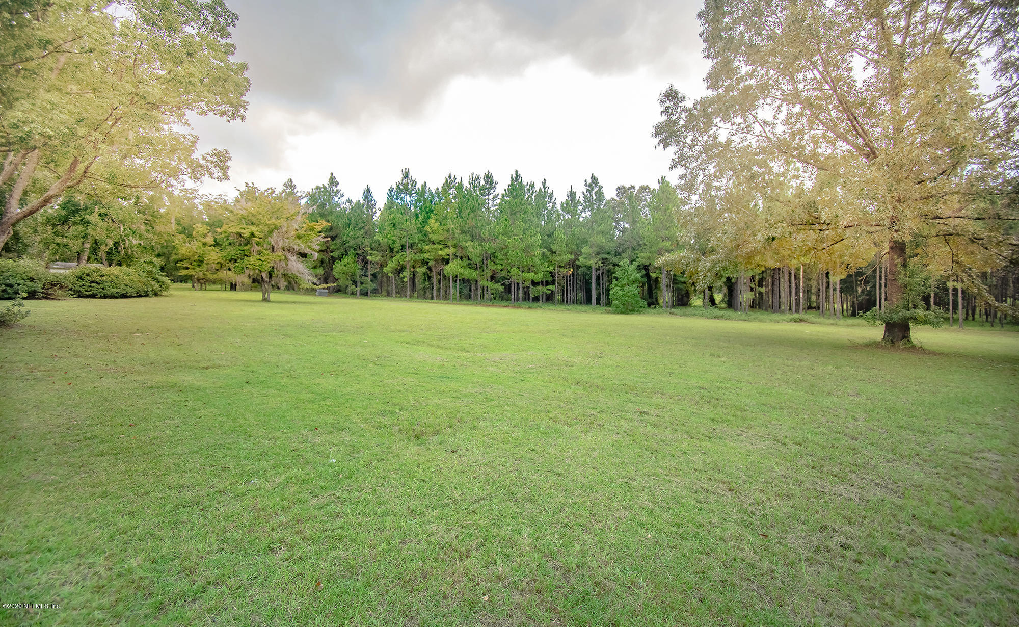 281105 Trigg Road Hilliard, FL 32046 - Photo 36 of 41 a view of outdoor space with green field and trees all around