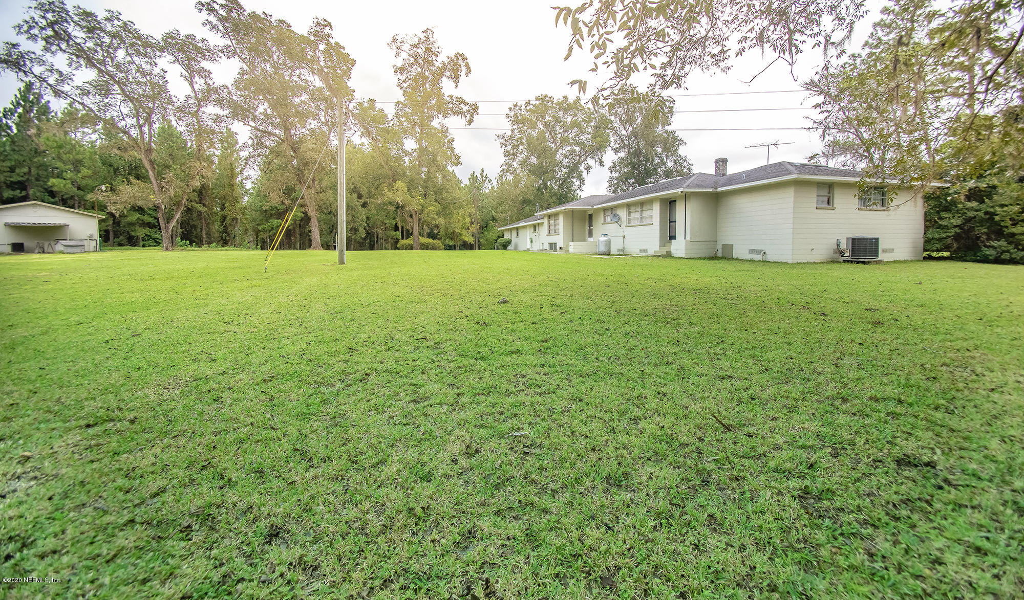 281105 Trigg Road Hilliard, FL 32046 - Photo 7 of 41 a view of a house with backyard and trees