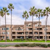 a view of a tall building next to a yard