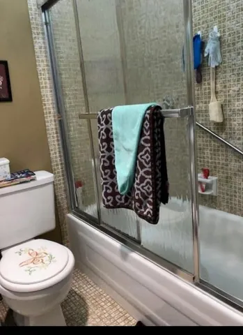a bathroom with a toilet and a shower