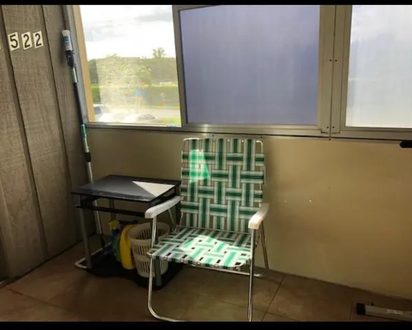 a balcony with table and chairs