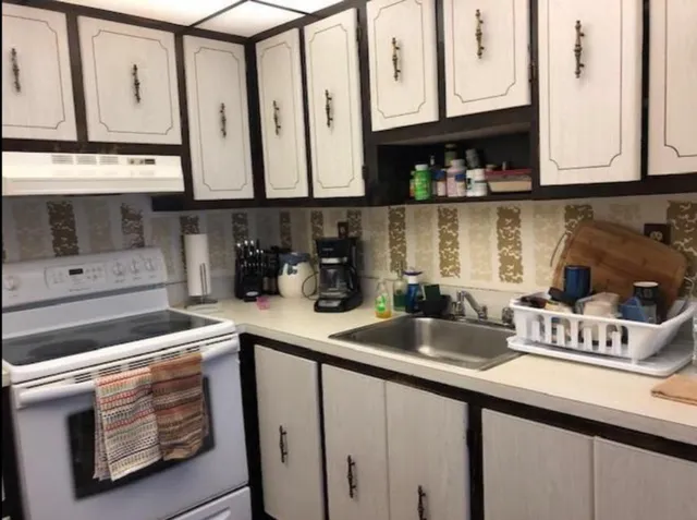 a kitchen with stainless steel appliances granite countertop a sink and cabinets
