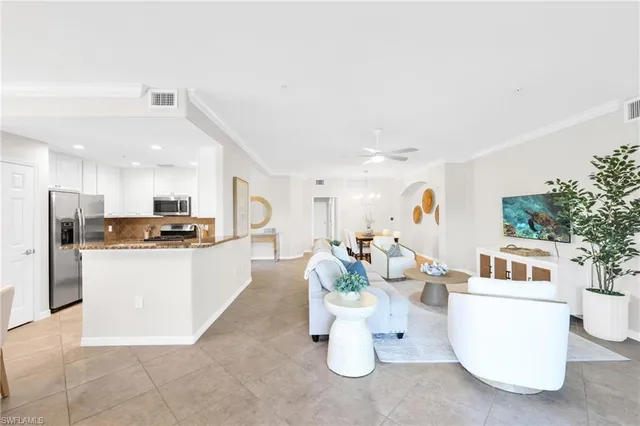 a living room with kitchen island furniture and a kitchen view
