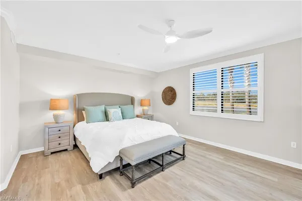 a bedroom with a large bed and a window