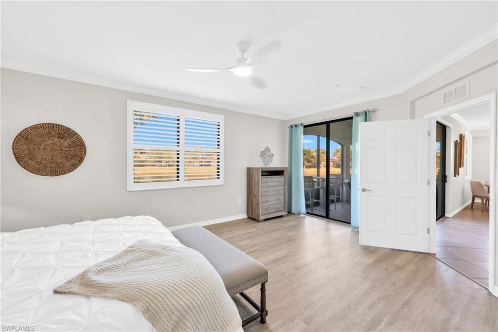 3159 Serena Lane, Unit 102 Naples, FL 34114 - Photo 22 of 42 a bedroom with a large bed and a window
