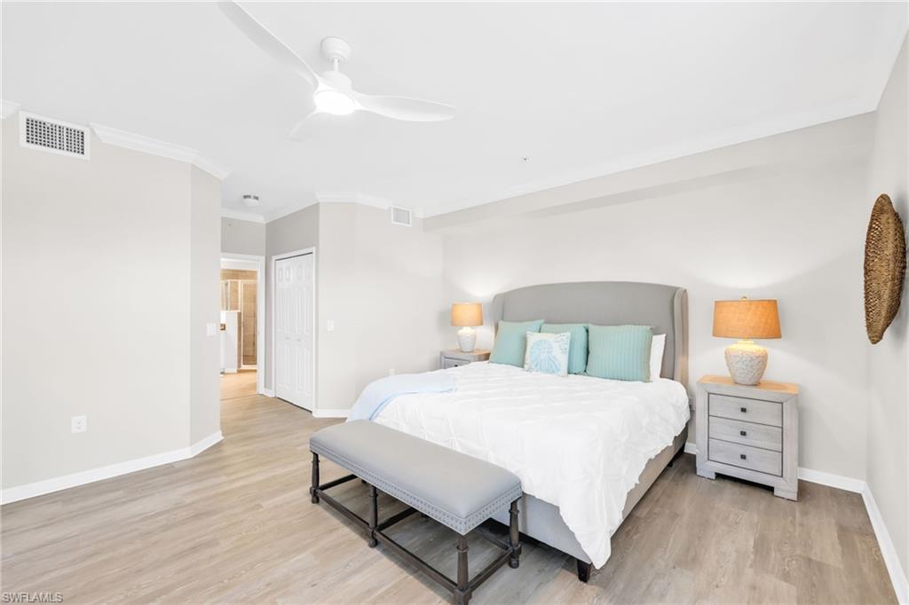 3159 Serena Lane, Unit 102 Naples, FL 34114 - Photo 23 of 42 a bedroom with a bed and a night stand
