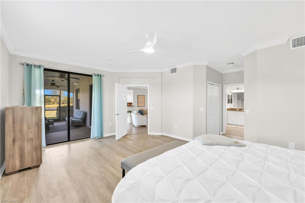 3159 Serena Lane, Unit 102 Naples, FL 34114 - Photo 24 of 42 a bedroom with a large bed and wooden floor