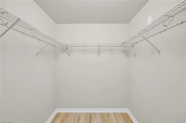 a bathroom with a granite countertop sink mirror bathtub and toilet