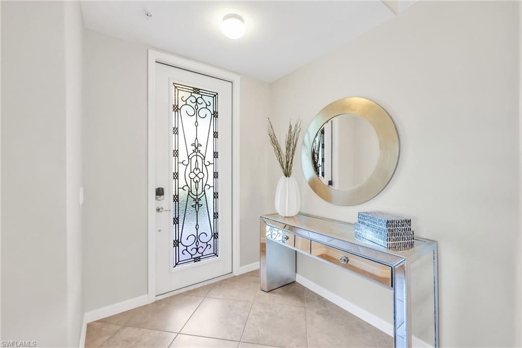 3159 Serena Lane, Unit 102 Naples, FL 34114 - Photo 3 of 42 a bathroom with a mirror a sink and a mirror