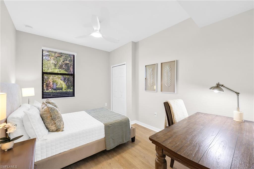 3159 Serena Lane, Unit 102 Naples, FL 34114 - Photo 31 of 42 a bedroom with a bed and wooden floor