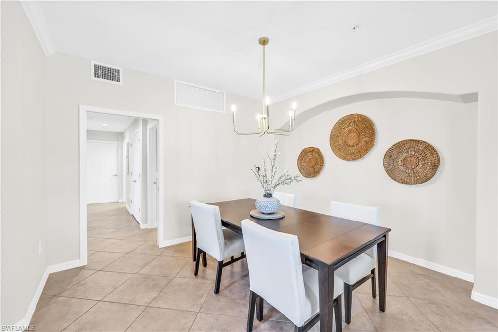 3159 Serena Lane, Unit 102 Naples, FL 34114 - Photo 6 of 42 a view of a dining room and a table and chairs